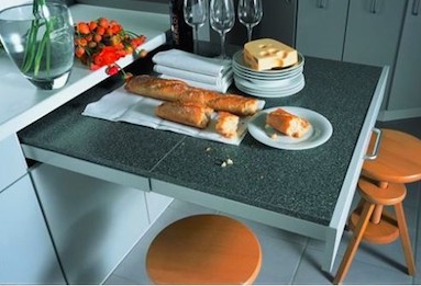 a pull out table can be used for extra seating or extra work space in a small kitchen